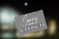 Sorry WeÃ¢â¬â¢re closed sign on a blured background